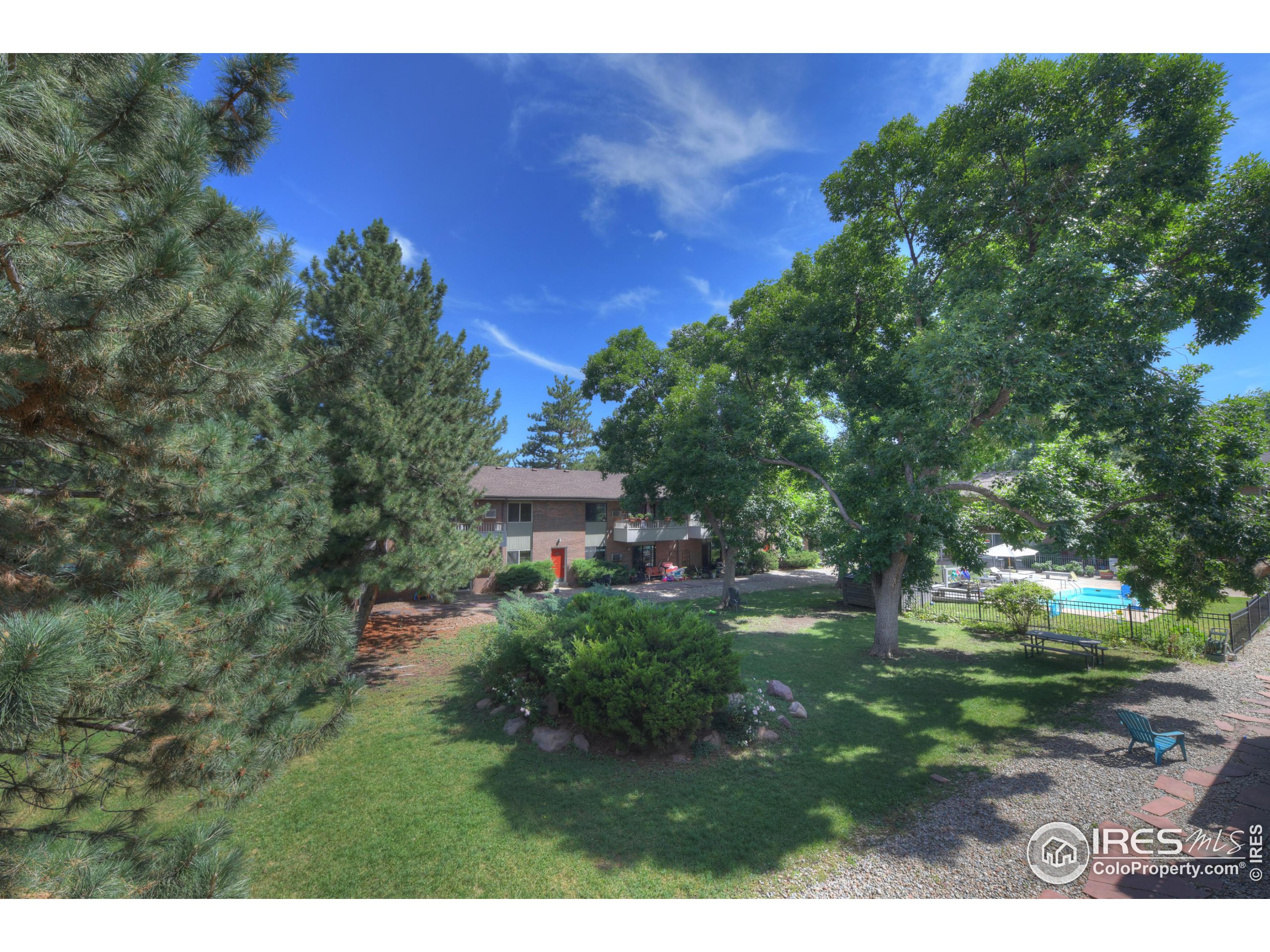 1895 Alpine Avenue, Unit E18 Boulder, CO 80304 - Photo 26 of 26 a backyard of a house with a yard and outdoor seating