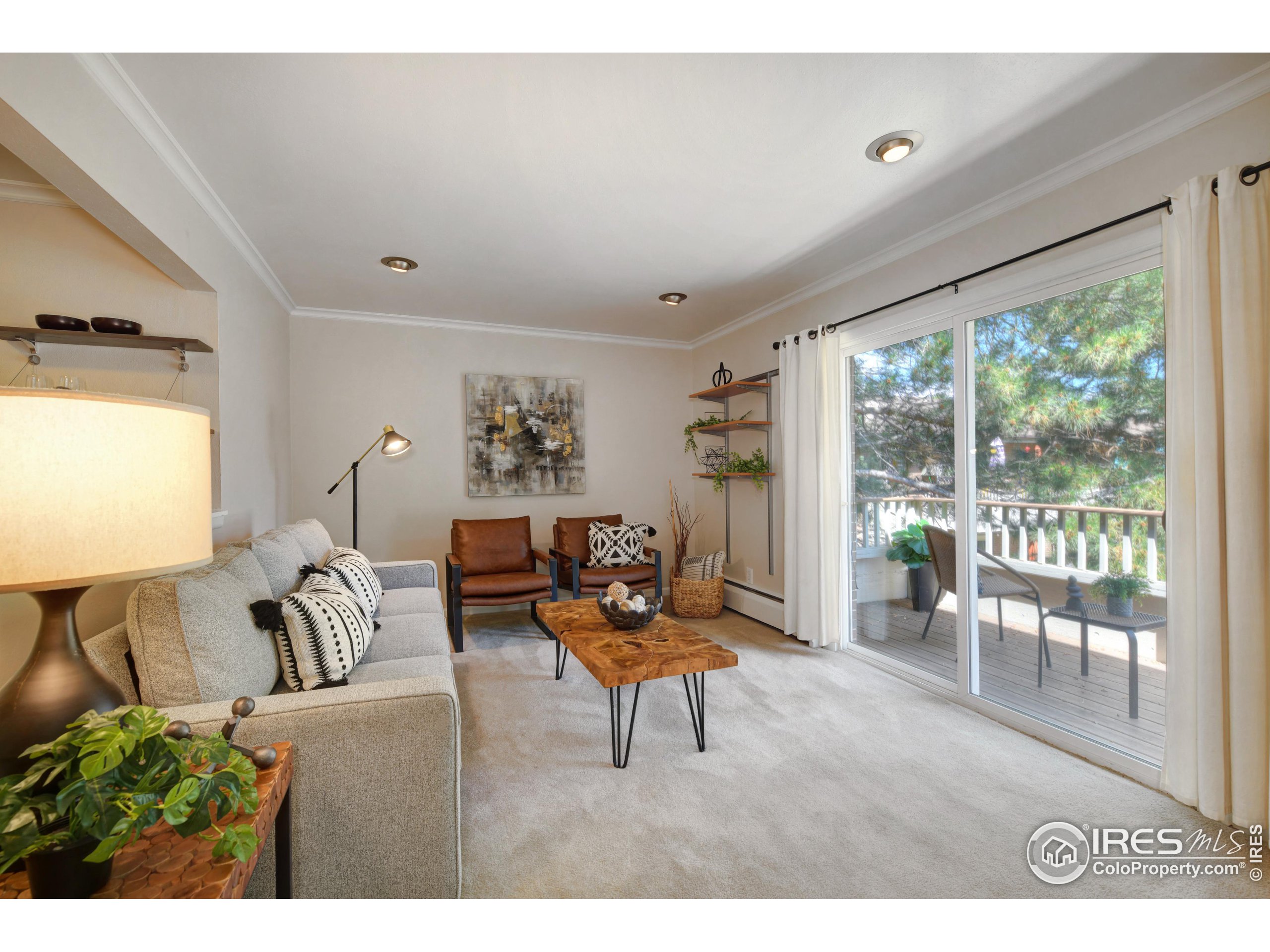 1895 Alpine Avenue, Unit E18 Boulder, CO 80304 - Photo 5 of 26 a living room with furniture and a large window