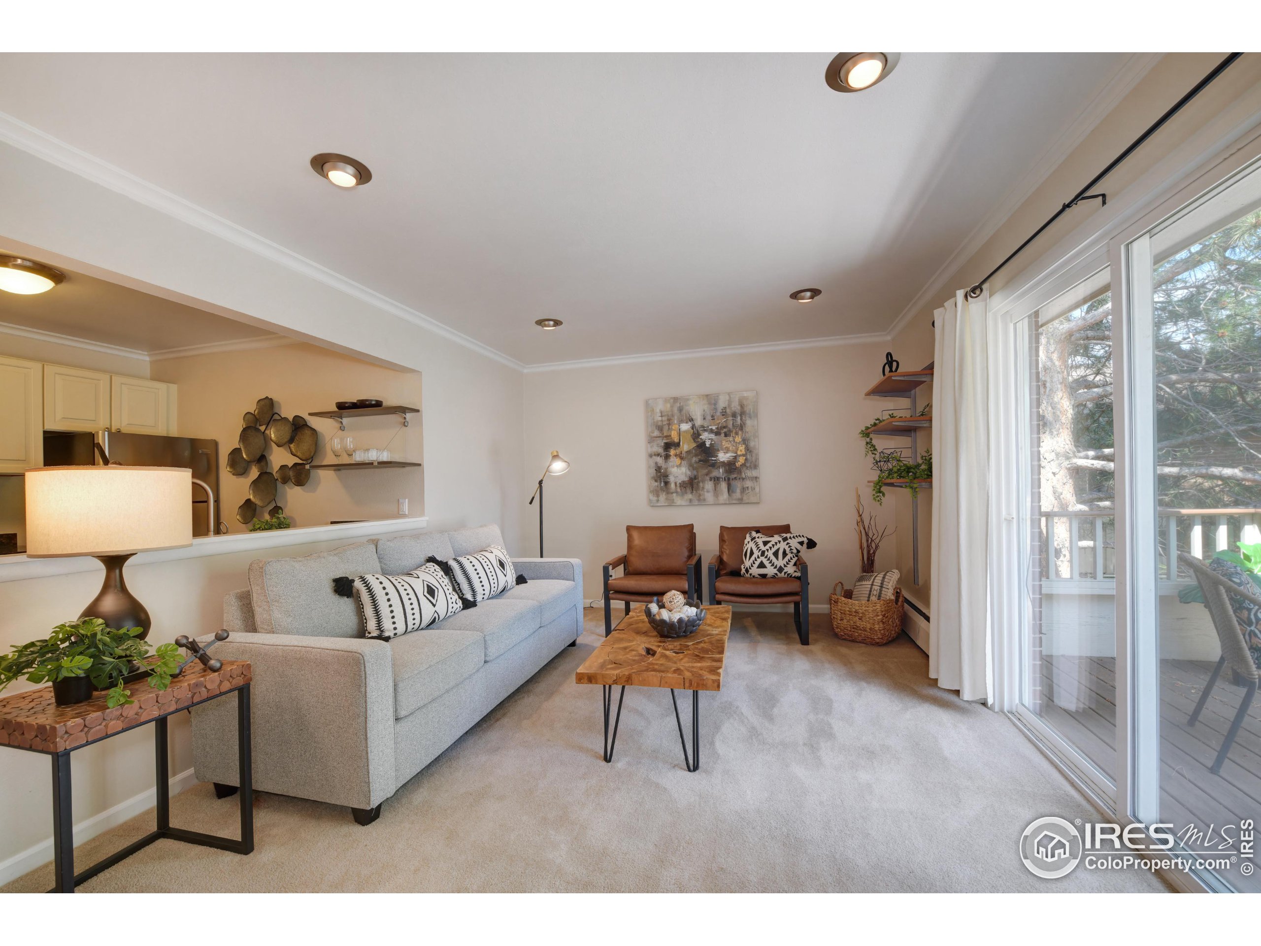 1895 Alpine Avenue, Unit E18 Boulder, CO 80304 - Photo 6 of 26 a living room with furniture and a large window