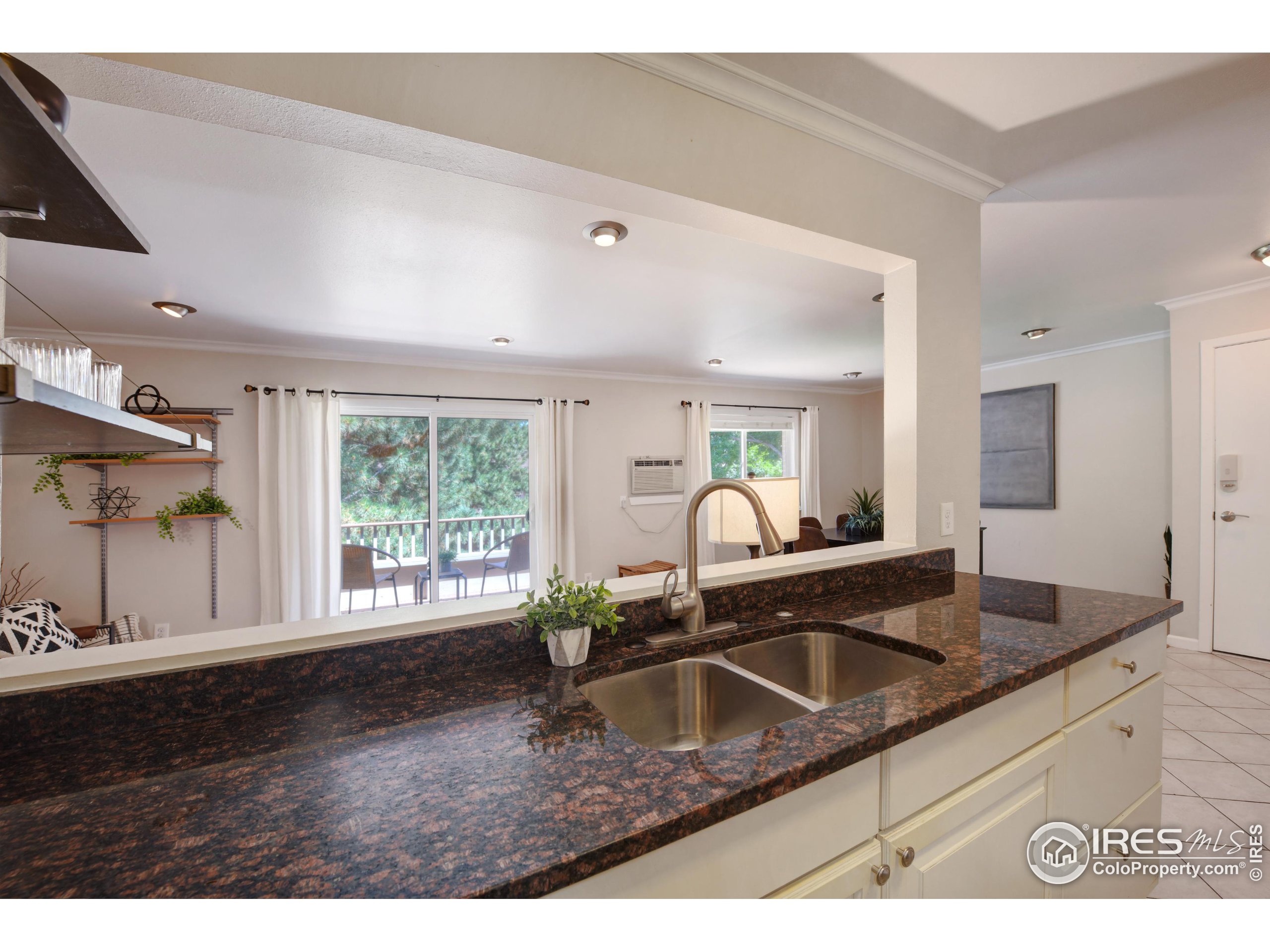 1895 Alpine Avenue, Unit E18 Boulder, CO 80304 - Photo 9 of 26 a kitchen with granite countertop a sink and a granite counter tops