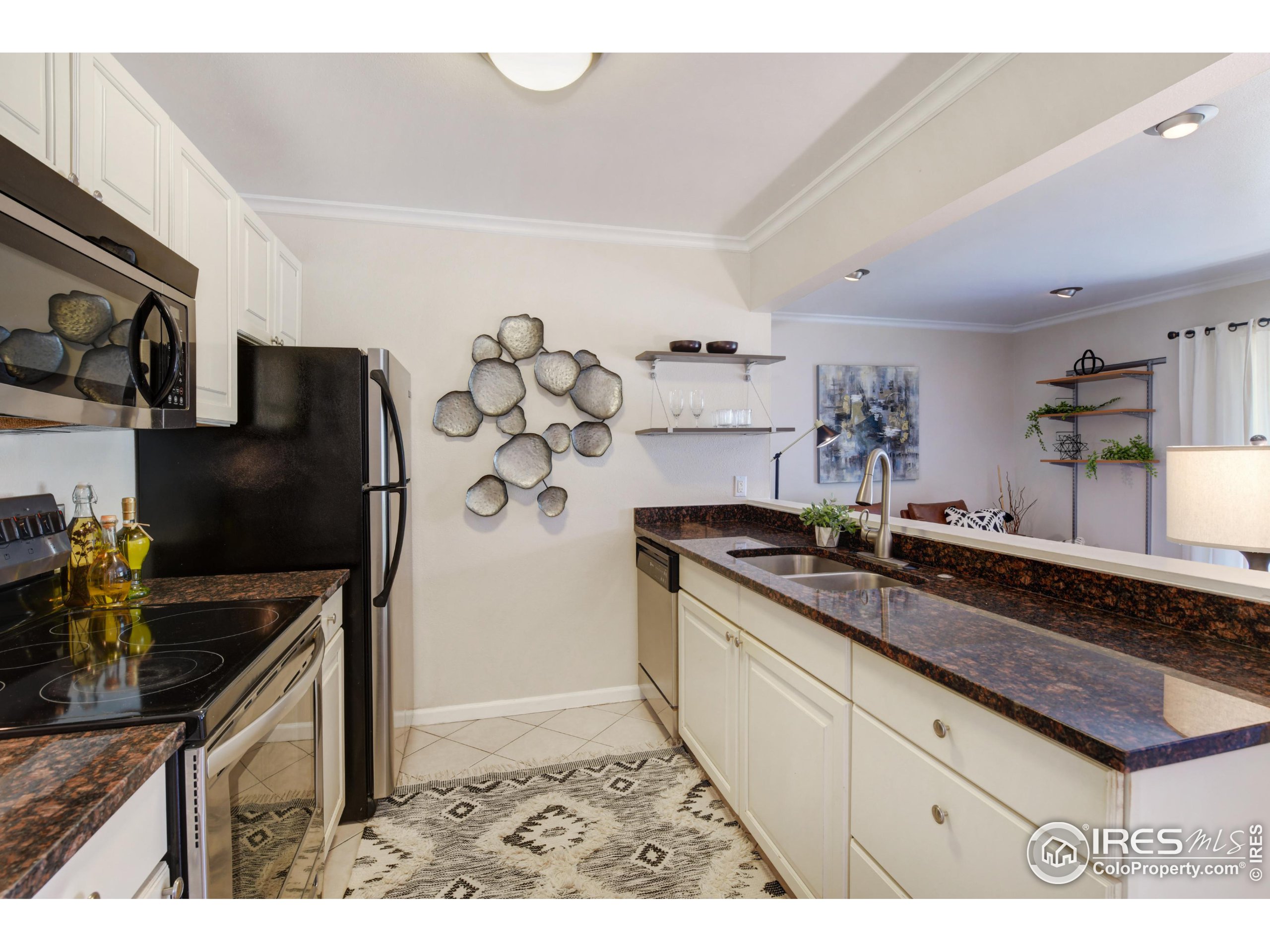 1895 Alpine Avenue, Unit E18 Boulder, CO 80304 - Photo 10 of 26 a kitchen with granite countertop a sink stove and refrigerator