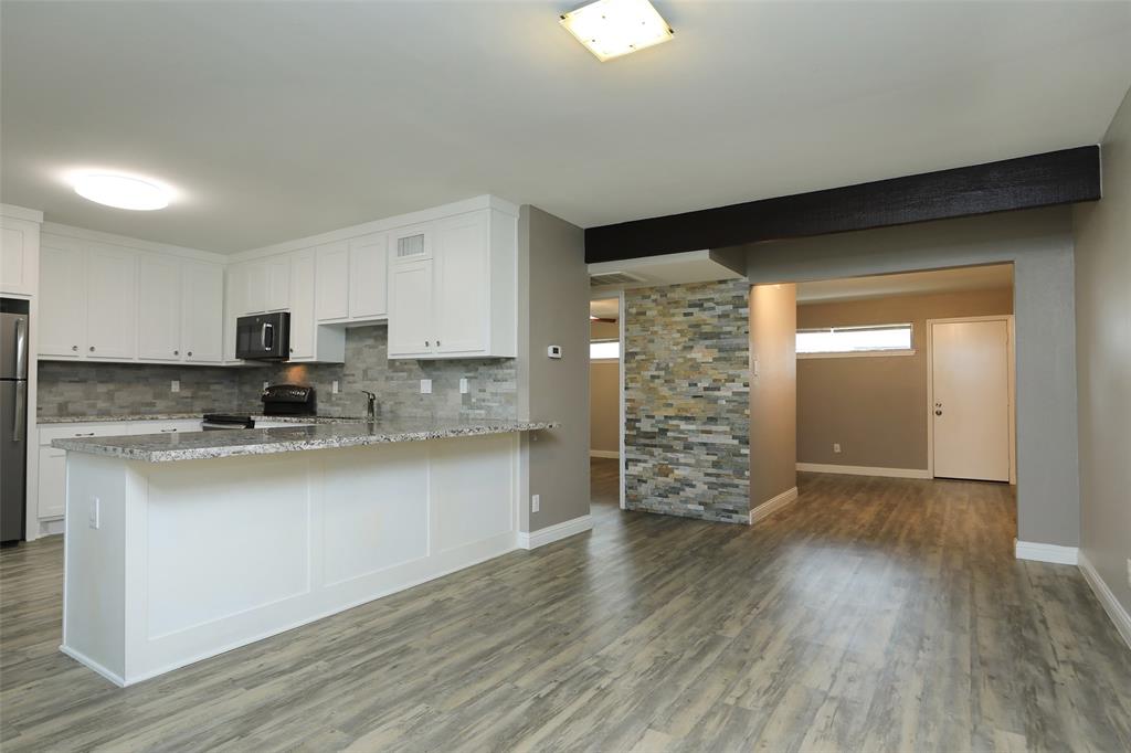 Stunning laminate flooring throughout the unit. Gourmet kitchen with granite counters, modern backsplash, custom cabinetry and stainless steel appliances