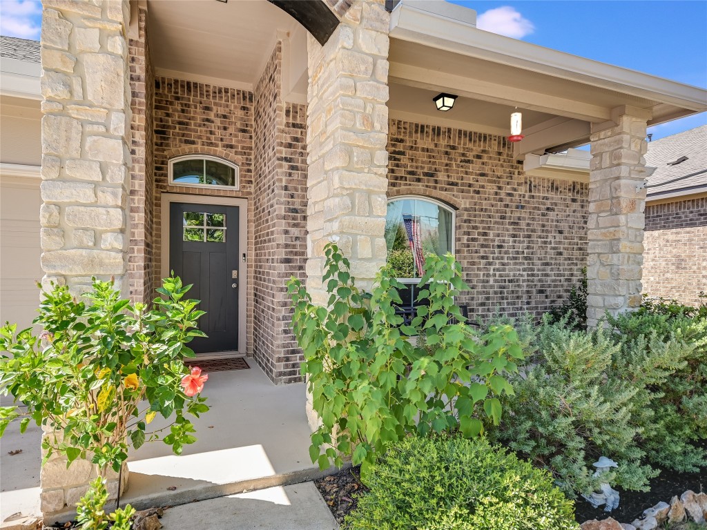 a view of a brick house with potted plants
