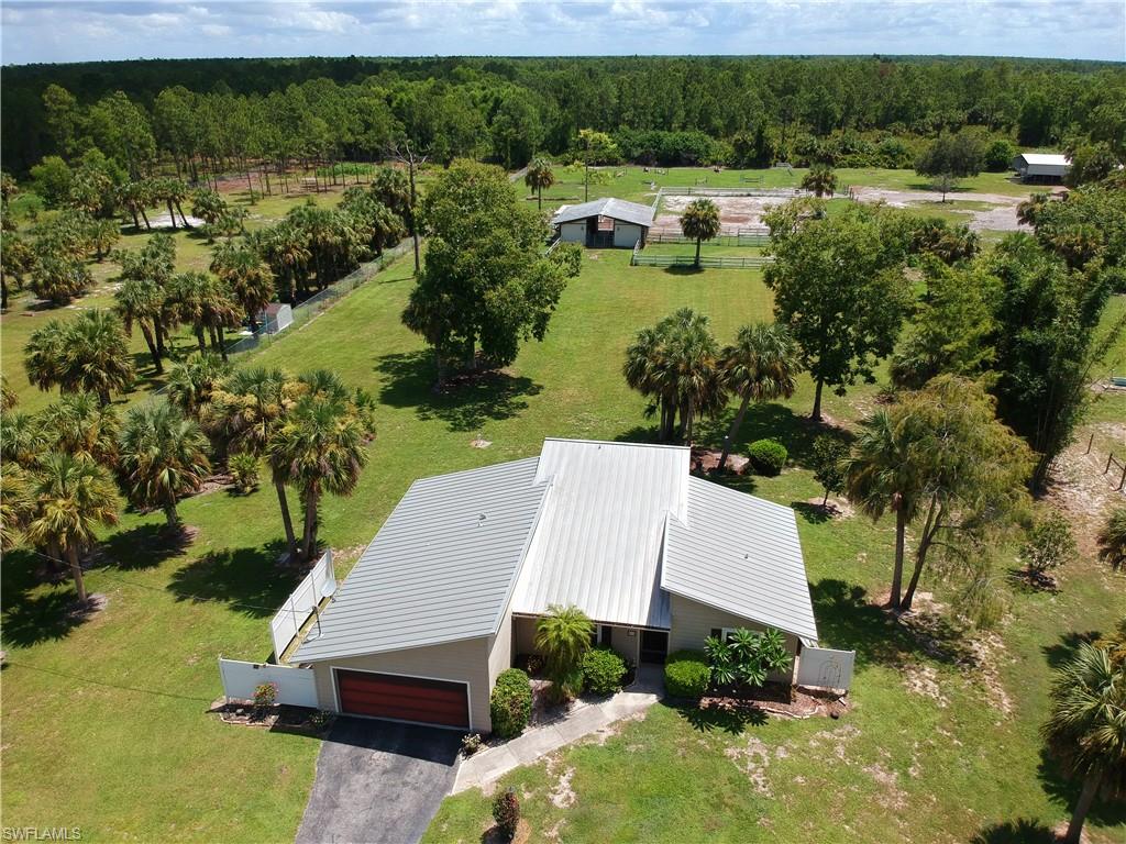 920 10th Street Southeast Naples, FL 34117 - Photo 1 of 16 an aerial view of a house with yard lake and outdoor seating