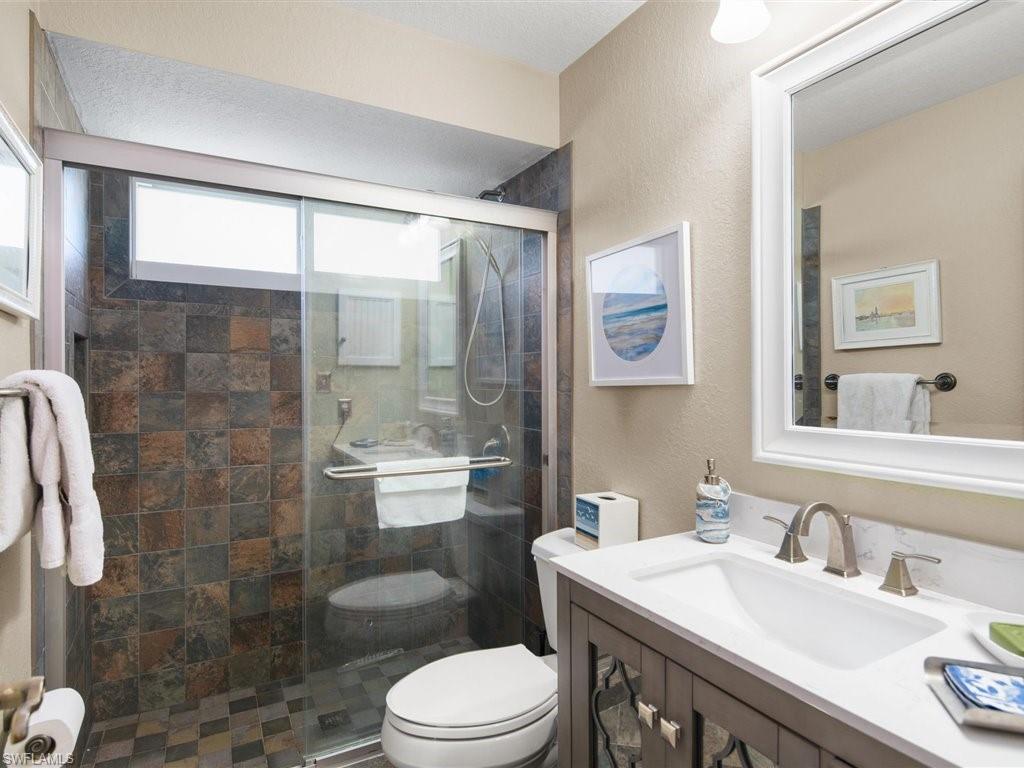 920 10th Street Southeast Naples, FL 34117 - Photo 15 of 16 a bathroom with a sink a toilet and shower
