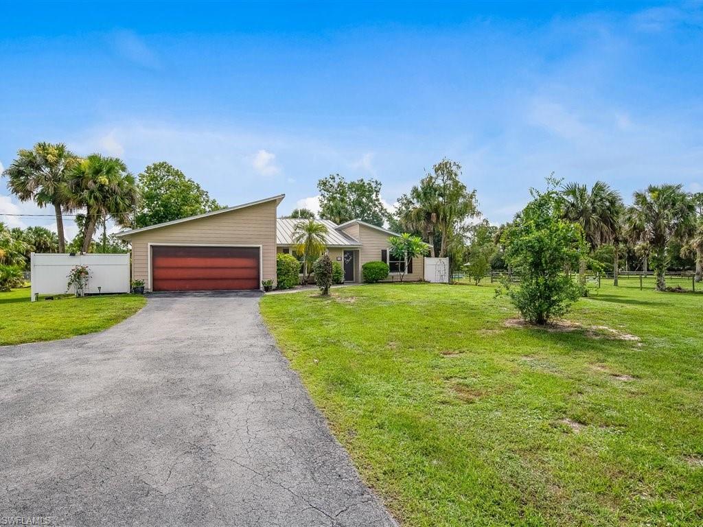920 10th Street Southeast Naples, FL 34117 - Photo 3 of 16 a green field with some trees in the background