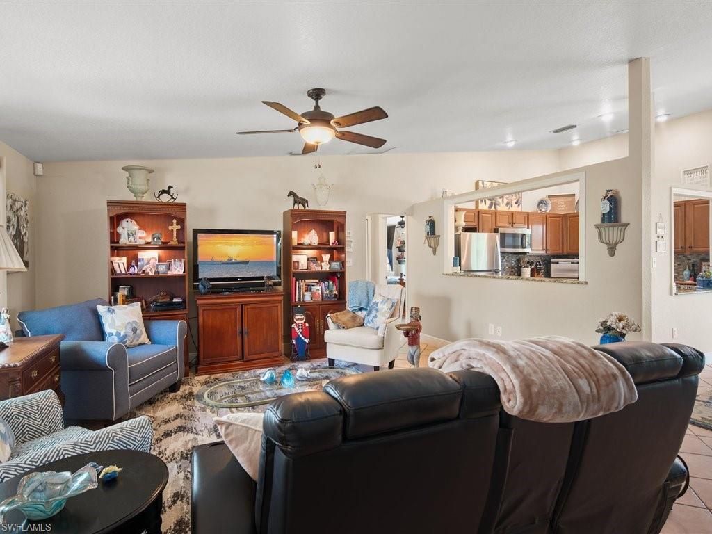 920 10th Street Southeast Naples, FL 34117 - Photo 4 of 16 a living room with furniture and a flat screen tv