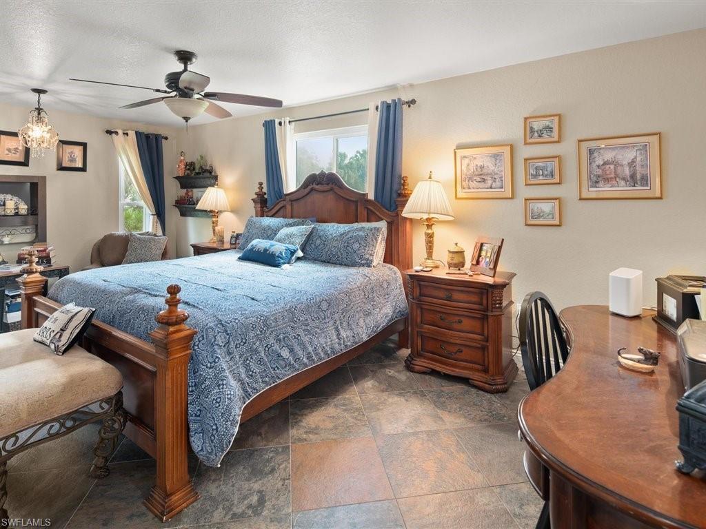 920 10th Street Southeast Naples, FL 34117 - Photo 7 of 16 a bedroom with a bed and a chandelier