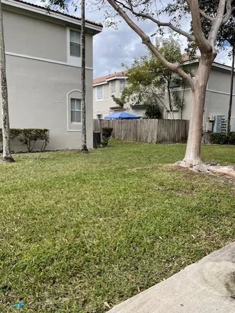 a backyard of a house with lots of green space