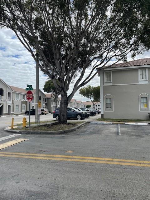 2900 Southeast 17th Avenue, Unit 103 Homestead, FL 33035 - Photo 16 of 16 a front view of house with garage and trees