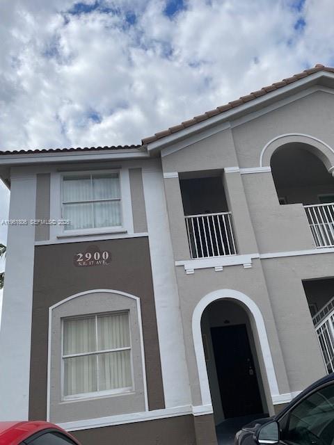 2900 Southeast 17th Avenue, Unit 103 Homestead, FL 33035 - Photo 2 of 16 a front view of a house with garage