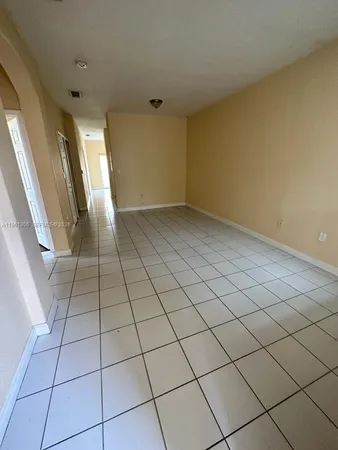 a view of an empty room and entryway