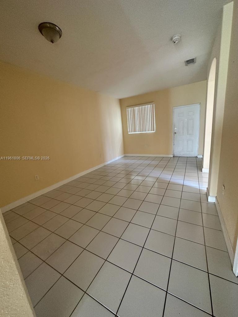 2900 Southeast 17th Avenue, Unit 103 Homestead, FL 33035 - Photo 7 of 16 a view of an empty room and window