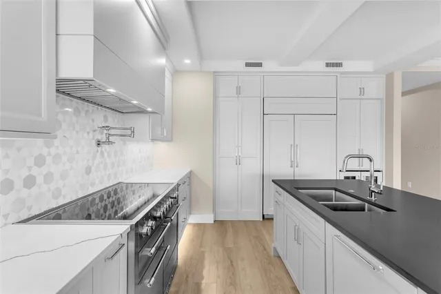 a kitchen with a sink stove and cabinets