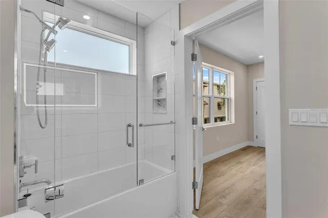 a bathroom with a bathtub and shower