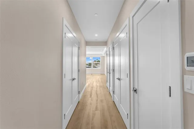a view of a hallway with wooden floor