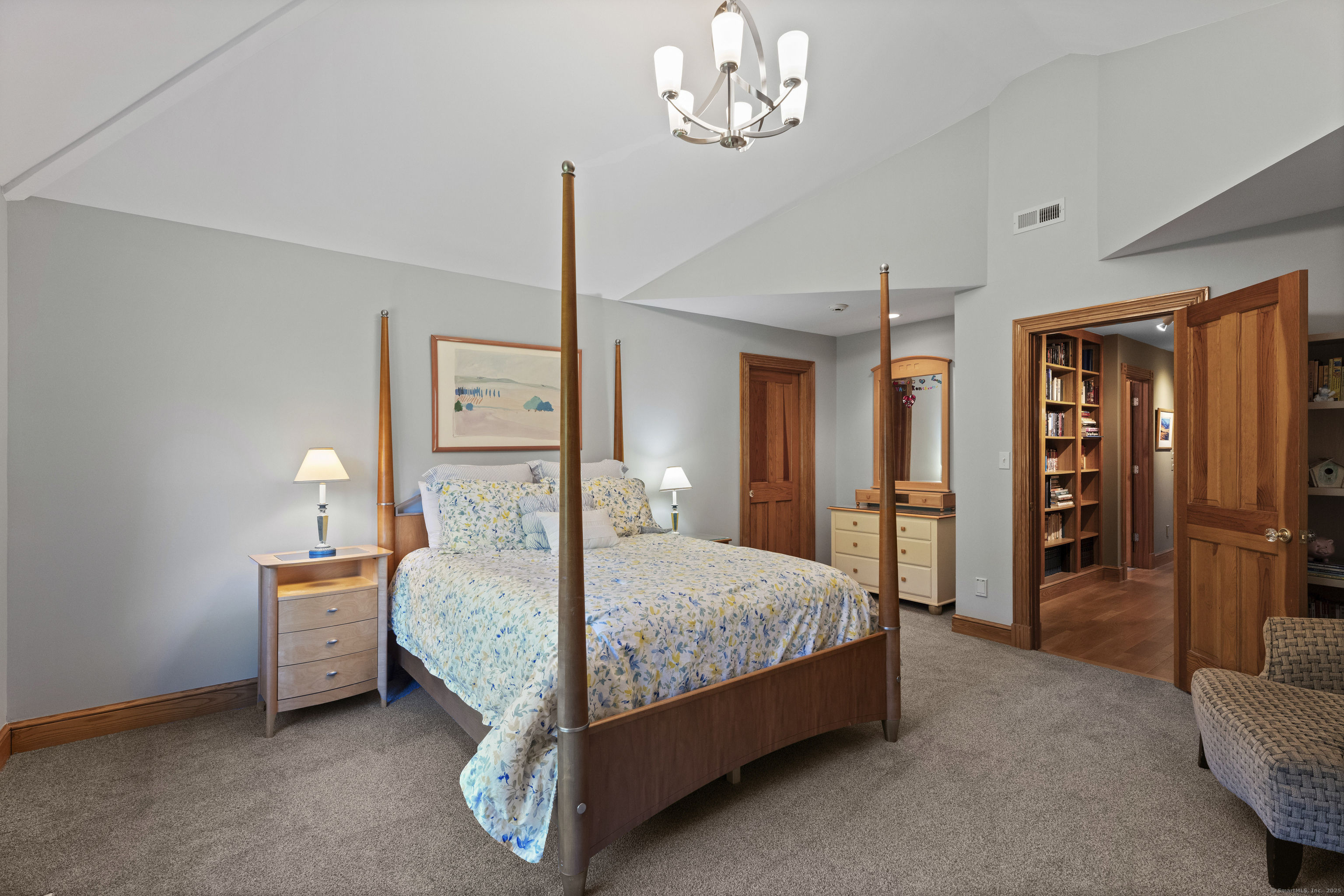 70 Morgan Road Salem, CT 06420 - Photo 20 of 38 a bedroom with a large bed and a chandelier