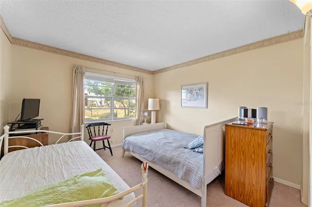 a bedroom with furniture and a window
