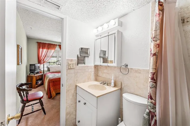 a bathroom with a sink toilet and a mirror