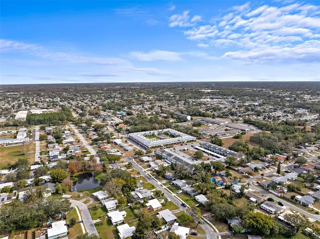 an aerial view of residential building with green space