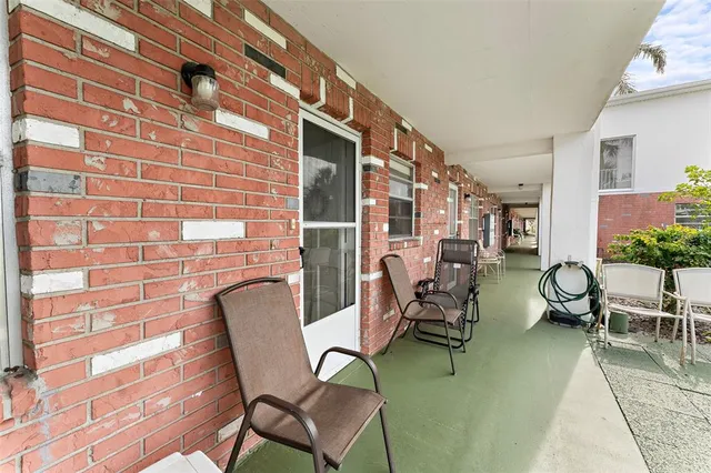 a view of a patio with table and chairs and potted plants