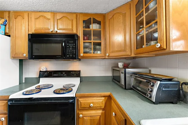 a kitchen with stainless steel appliances granite countertop a stove and a microwave