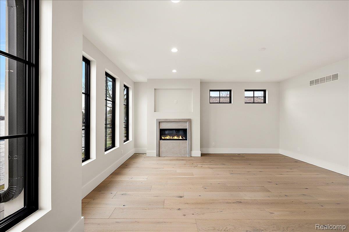 13459 Haddon Street Fenton, MI 48430 - Photo 33 of 84 Unfurnished living room with recessed lighting, light wood finished floors, and a glass covered fireplace