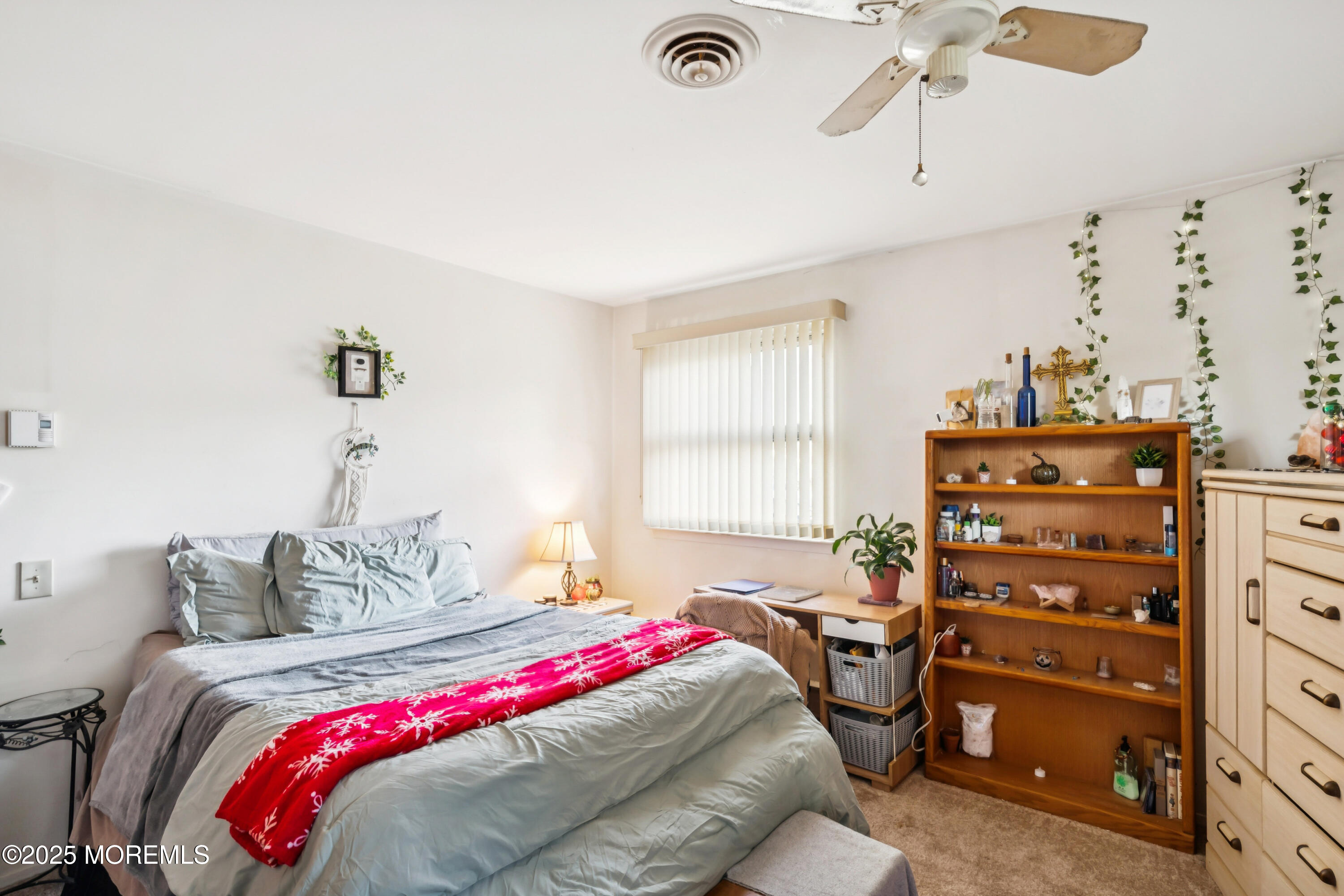 10A Alpine Road, Unit 63 Manchester Township, NJ 08759 - Photo 14 of 25 a bedroom with a bed and a chandelier