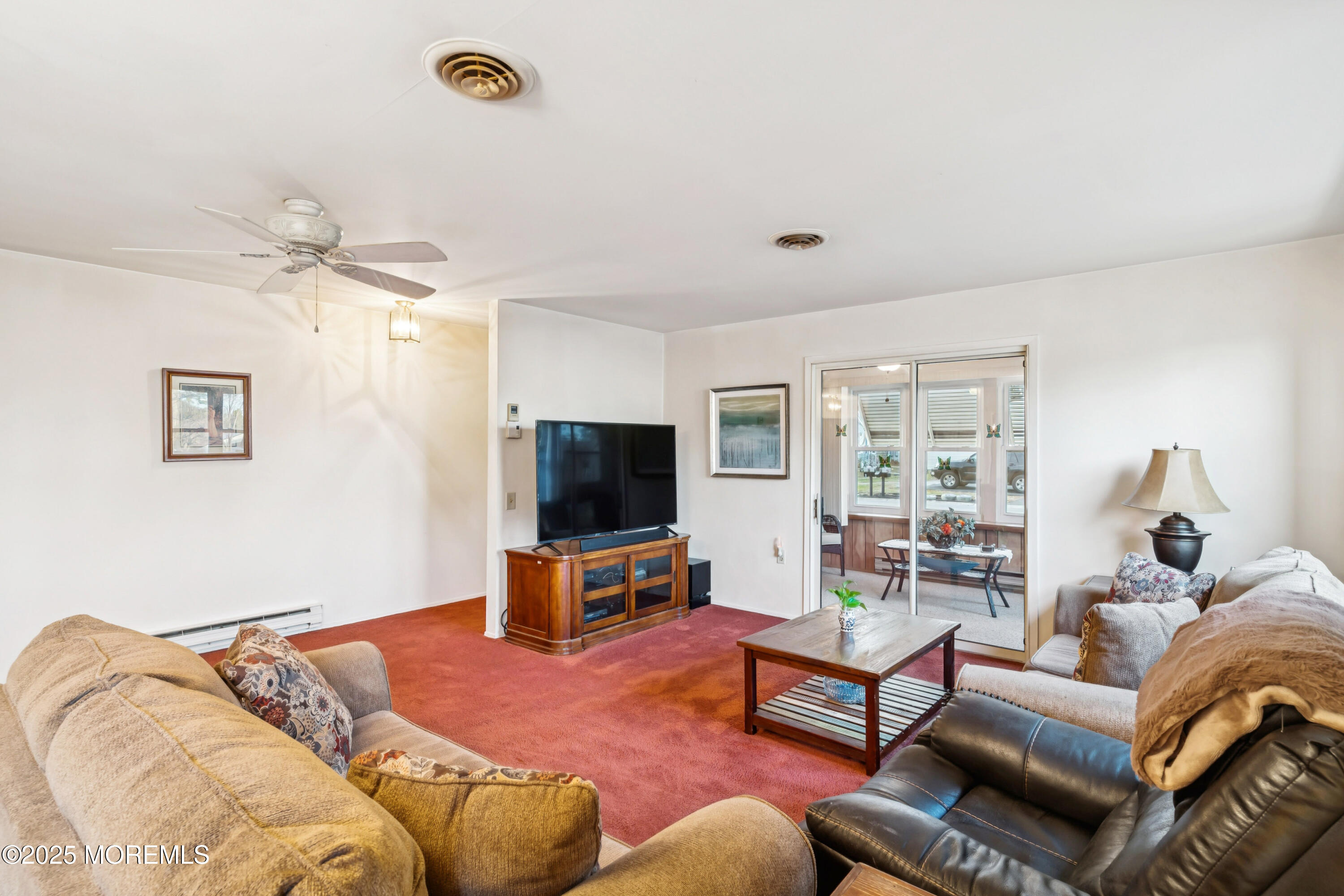 10A Alpine Road, Unit 63 Manchester Township, NJ 08759 - Photo 18 of 25 a bedroom with a bed and a flat screen tv