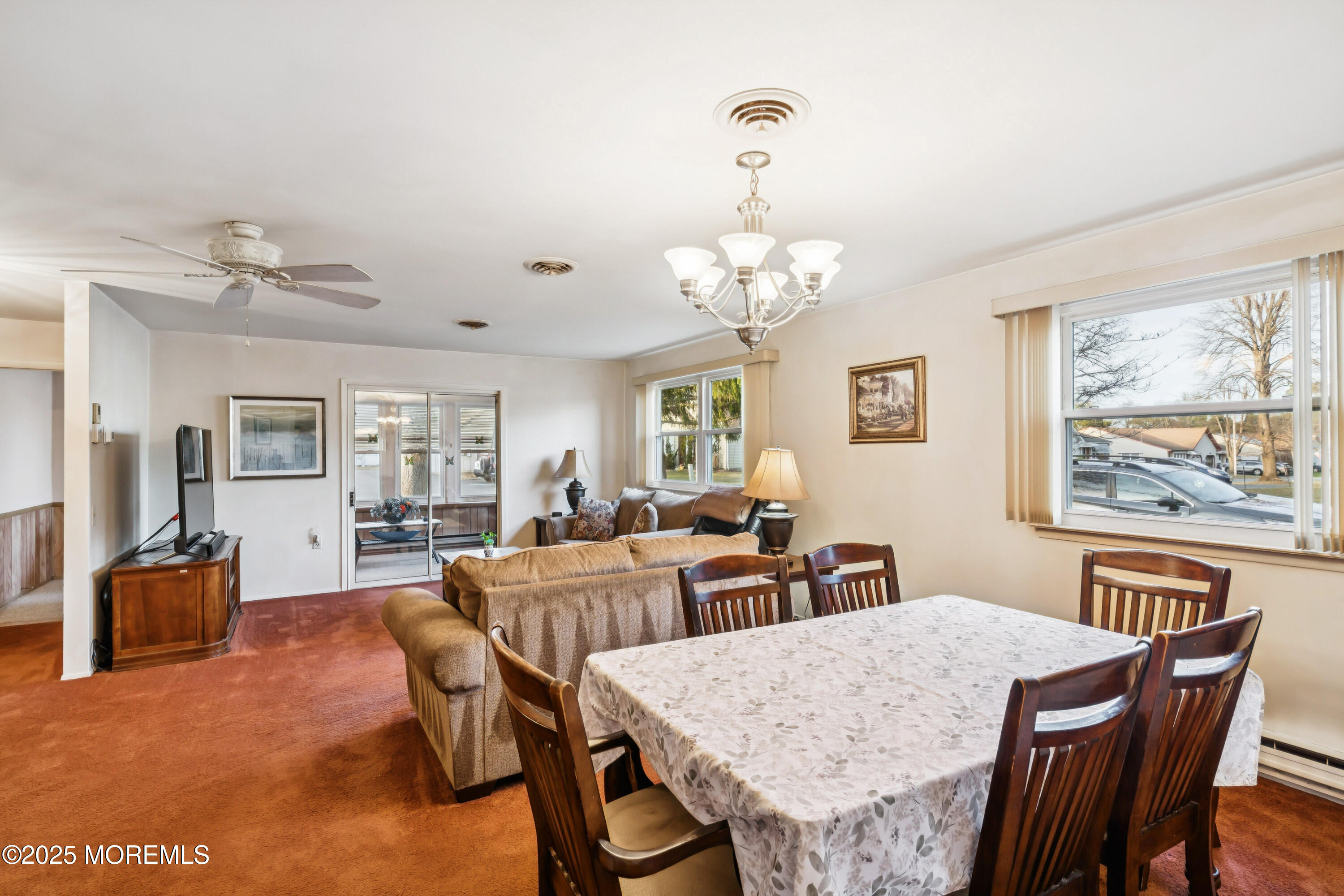 10A Alpine Road, Unit 63 Manchester Township, NJ 08759 - Photo 20 of 25 a view of a dining room with furniture a chandelier and wooden floor