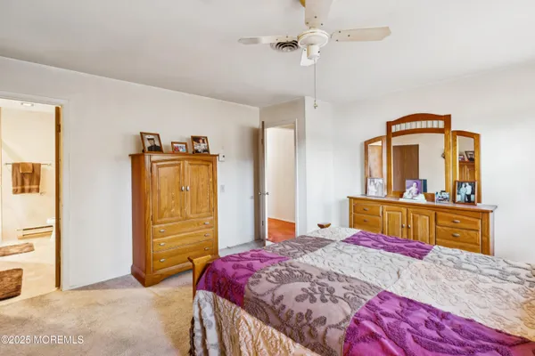 a bedroom with a bed and a dresser