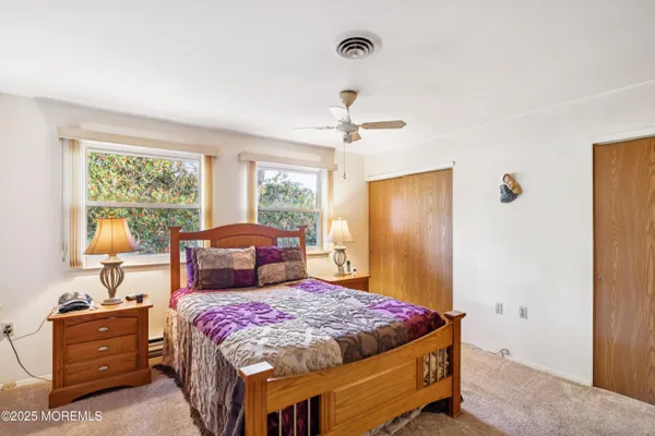 a bedroom with a large bed and a dresser