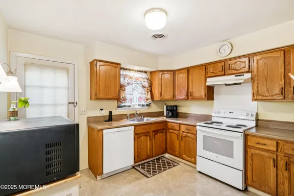 a kitchen with a sink stove and cabinets