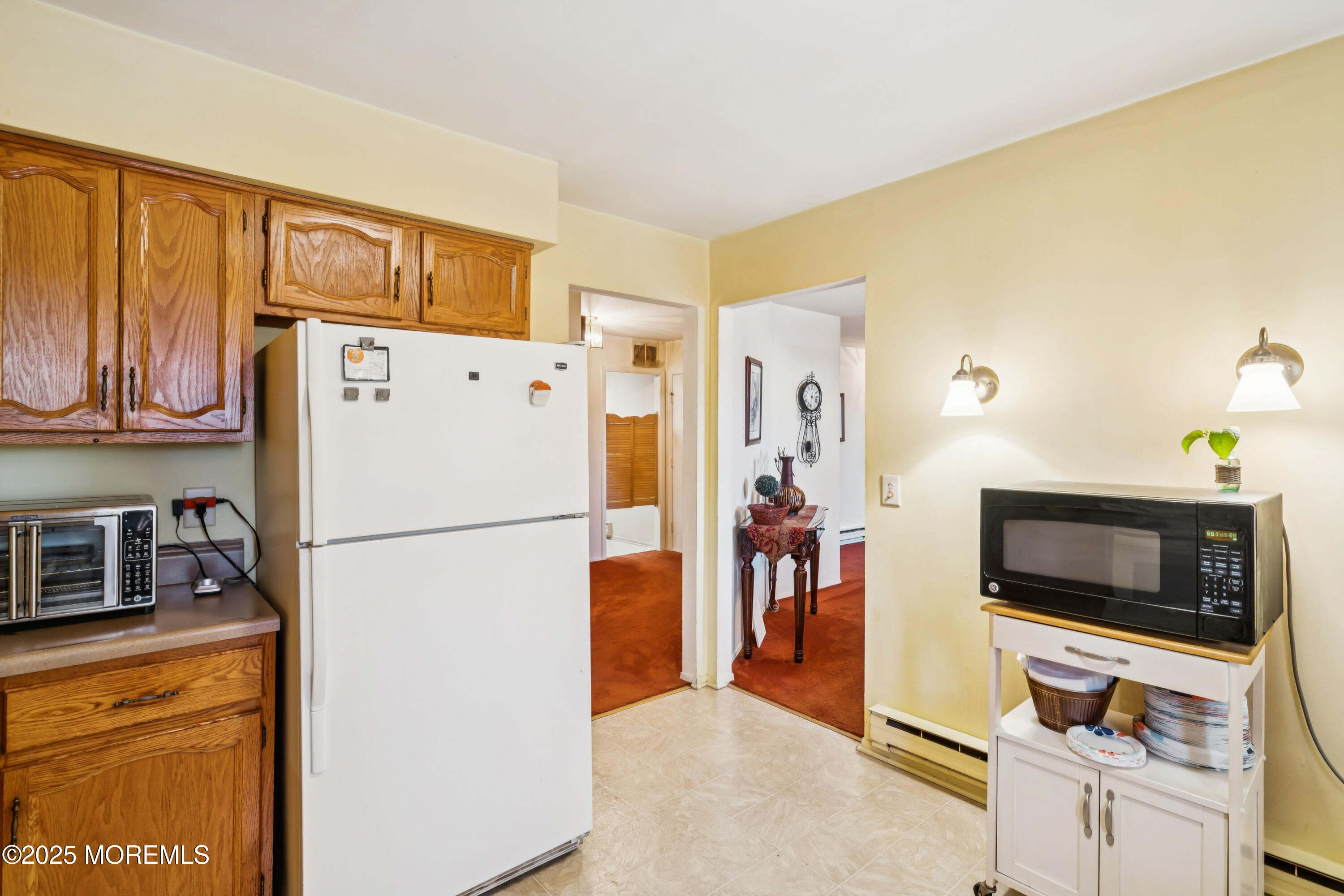 10A Alpine Road, Unit 63 Manchester Township, NJ 08759 - Photo 10 of 25 a white refrigerator freezer and a stove sitting inside of a kitchen