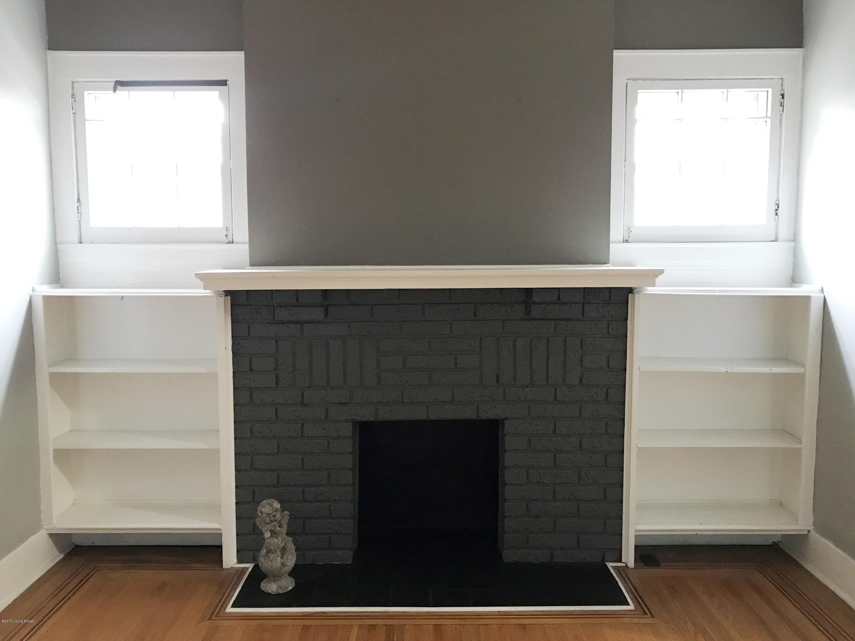 2406 Sherry Road Louisville, KY 40217 - Photo 11 of 48 Decorative mantled fireplace and built-in shelving