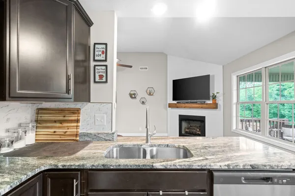 a kitchen with granite countertop a sink and a stove