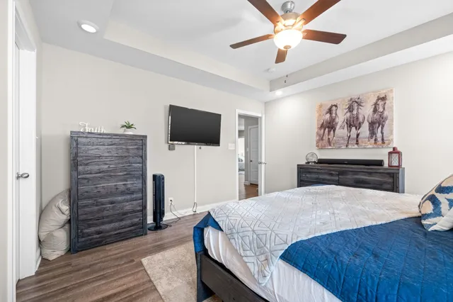 a bedroom with a bed and a flat screen tv