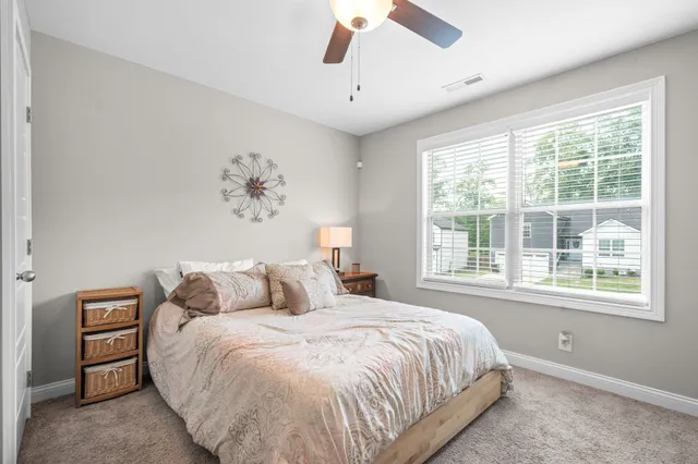 a bedroom with a large bed and a window