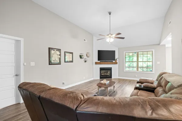 a living room with furniture and a flat screen tv