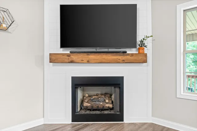 a view of fireplace with a flat screen tv