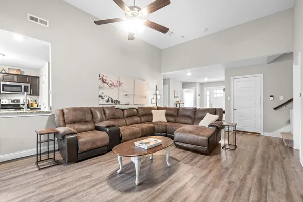 a living room with furniture and a wooden floor