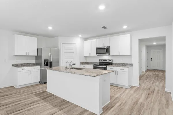 a view of a kitchen with wooden floor