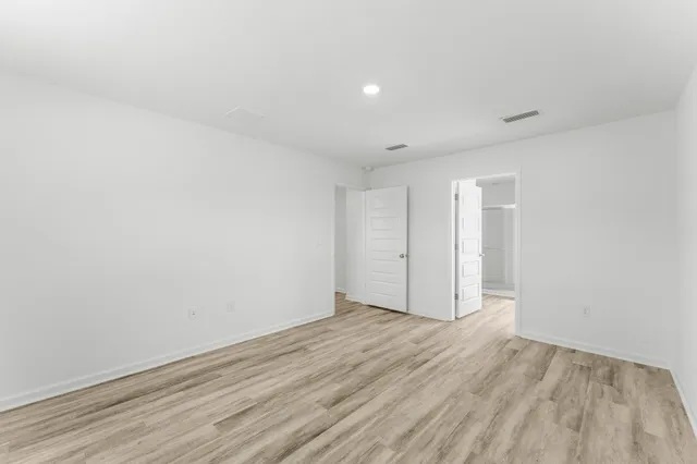 a bathroom with a granite countertop double vanity sink a mirror and a bathtub