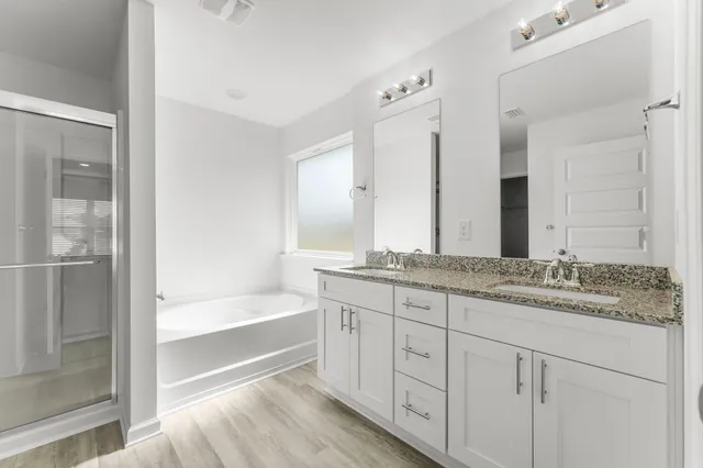 a bathroom with a bathtub and shower