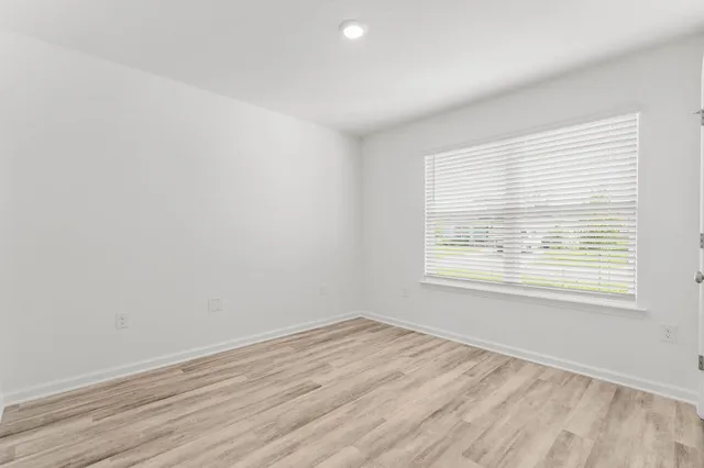 an empty room with wooden floor
