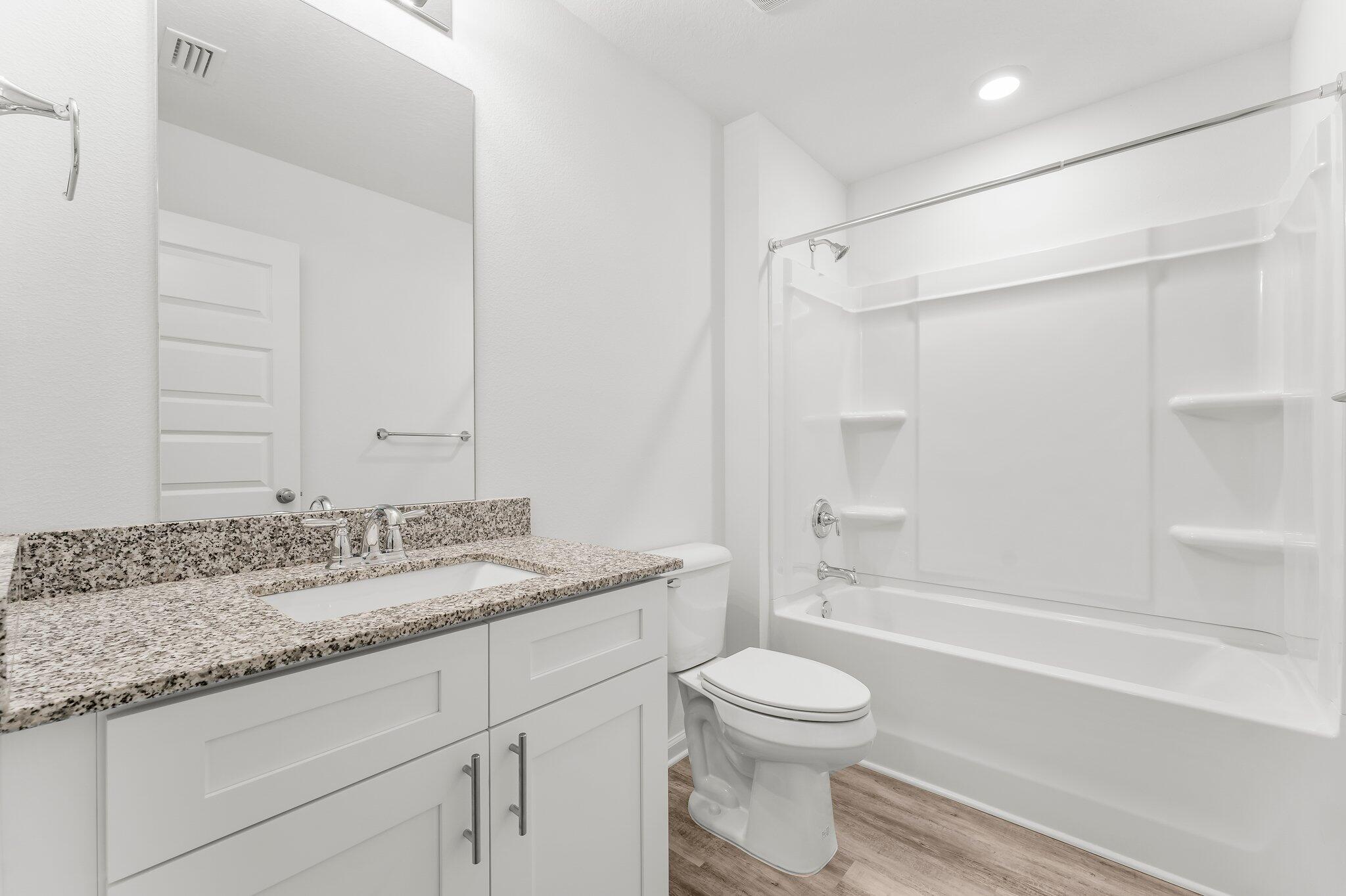453 Riverwalk Circle Freeport, FL 32439 - Photo 8 of 35 a bathroom with a granite countertop sink toilet and shower