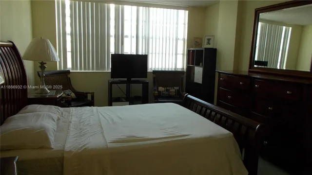 a bedroom with a bed and flat screen tv