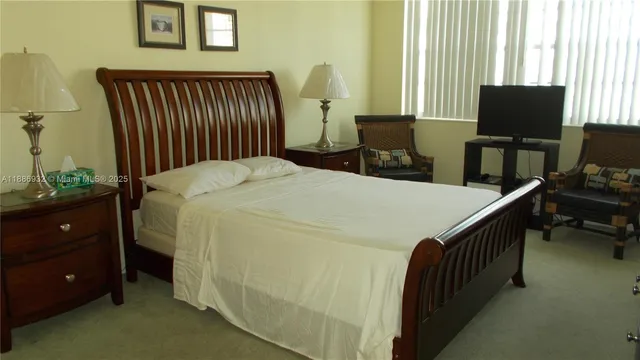 a bed room with a bed and a television