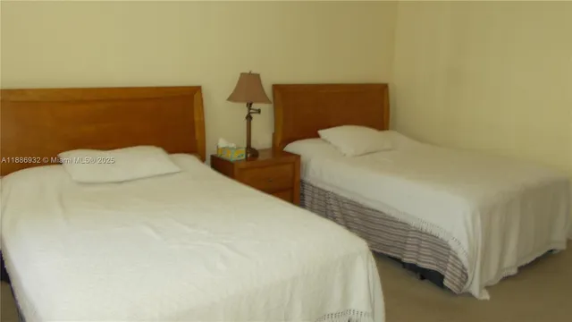 a bedroom with a bed and a night stand