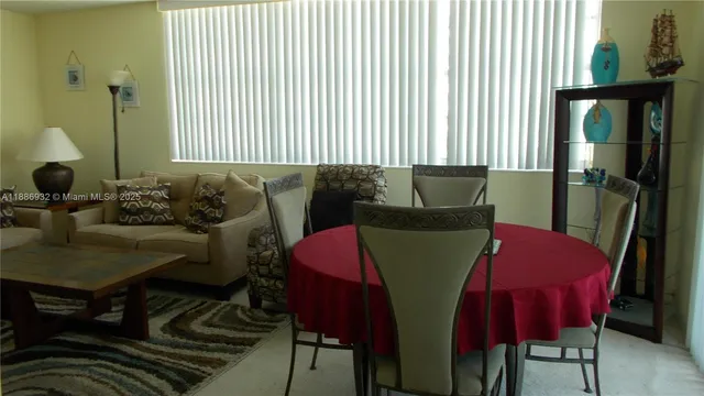 a view of a dining room with furniture and a window